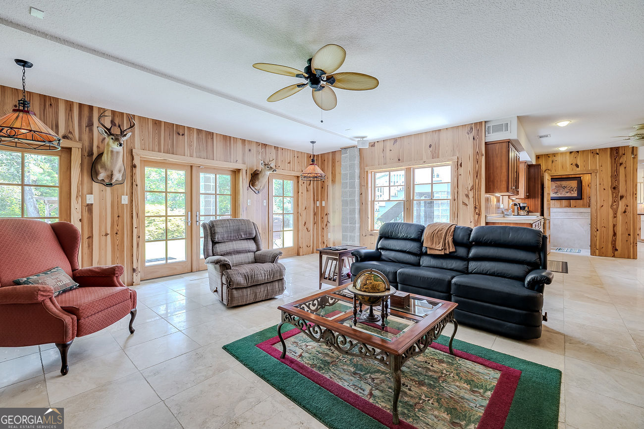 165 Shearouse Landing Brooklet, GA 30415 - Photo 52 of 78 a living room with furniture a window and a chandelier