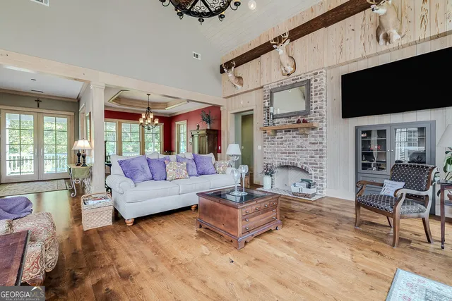 a living room with furniture a fireplace and a flat screen tv