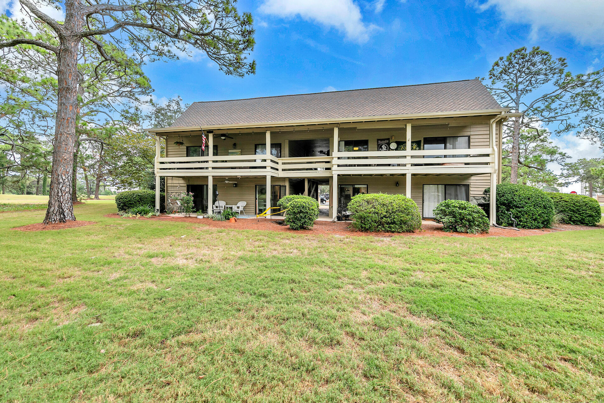 277 Sunset Bay, Unit 27A Miramar Beach, FL 32550 - Photo 1 of 42 a front view of a building with a garden