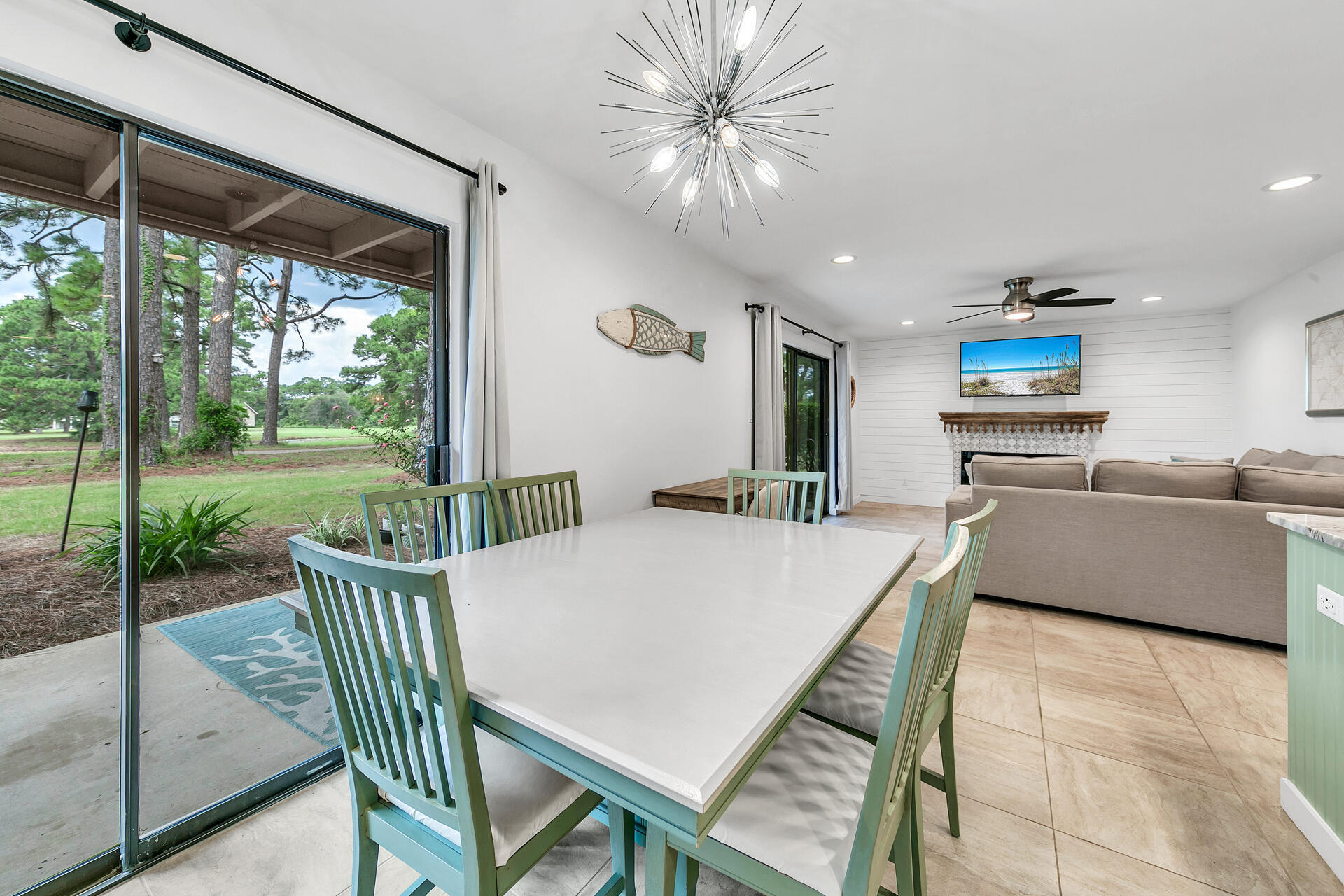 277 Sunset Bay, Unit 27A Miramar Beach, FL 32550 - Photo 11 of 42 a view of a dining room with furniture large windows and wooden floor
