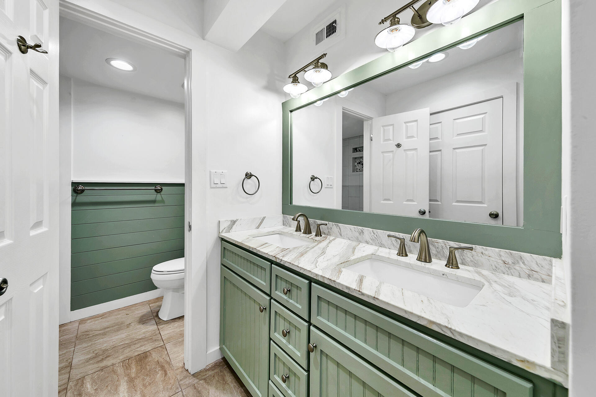 277 Sunset Bay, Unit 27A Miramar Beach, FL 32550 - Photo 21 of 42 a bathroom with a granite countertop double vanity sink a mirror and a toilet