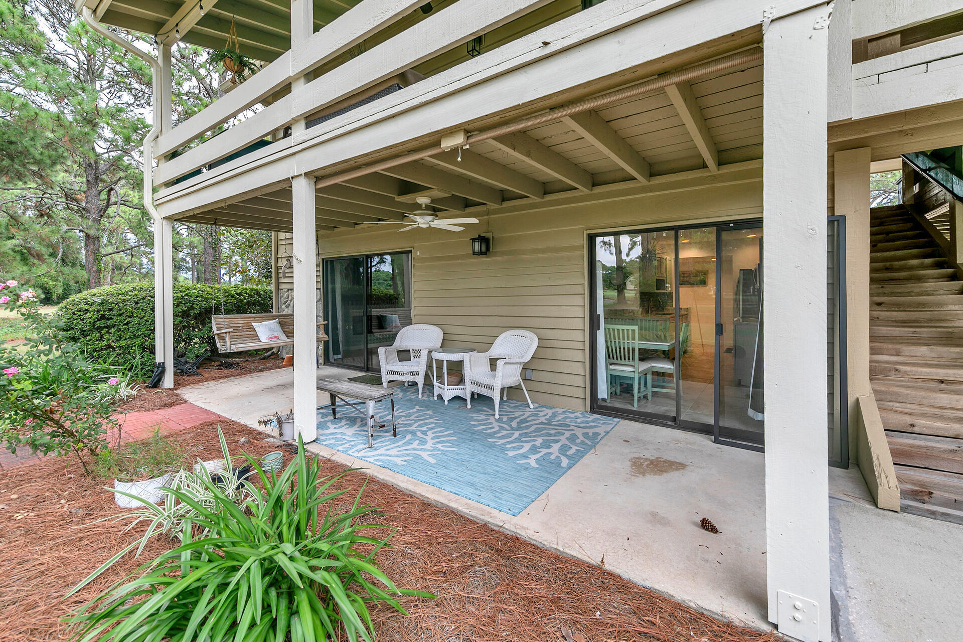 277 Sunset Bay, Unit 27A Miramar Beach, FL 32550 - Photo 33 of 42 a view of a patio with table and chairs and wooden floor
