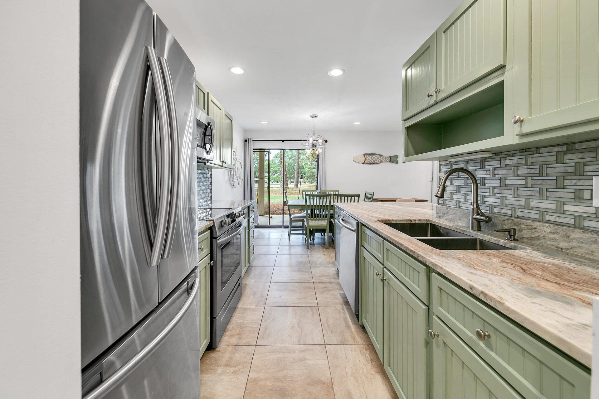 277 Sunset Bay, Unit 27A Miramar Beach, FL 32550 - Photo 7 of 42 a kitchen with stainless steel appliances granite countertop a refrigerator a sink and a stove