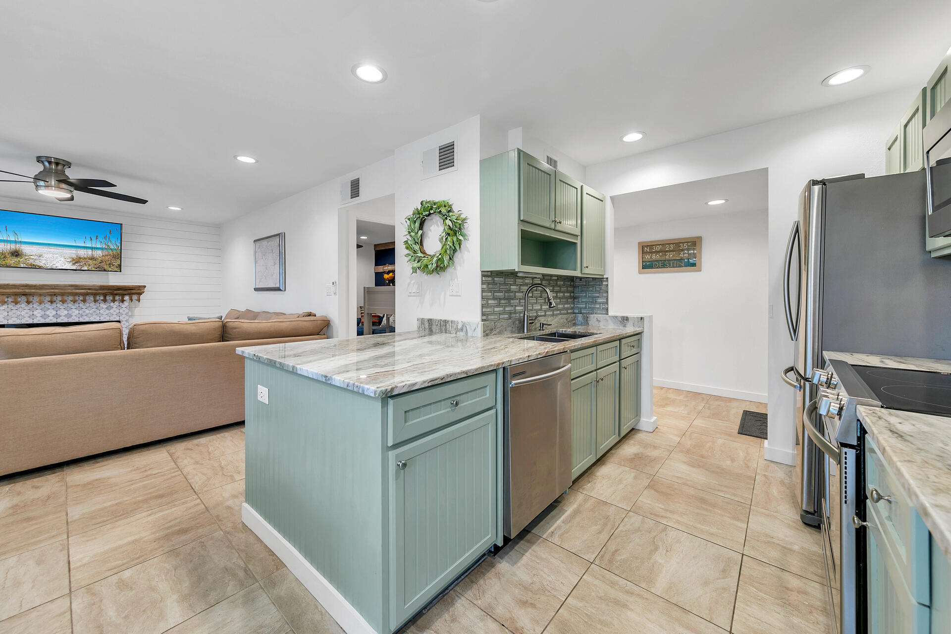 277 Sunset Bay, Unit 27A Miramar Beach, FL 32550 - Photo 10 of 42 a kitchen with stainless steel appliances granite countertop a sink and a refrigerator