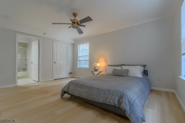 a spacious bedroom with a bed and a window