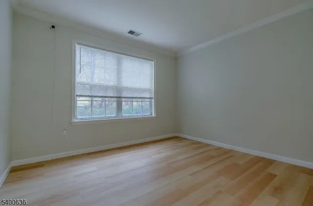 a bathroom with a granite countertop sink vanity mirror and toilet