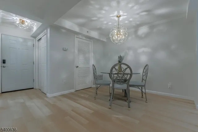 a view of a dining room with furniture and chandelier