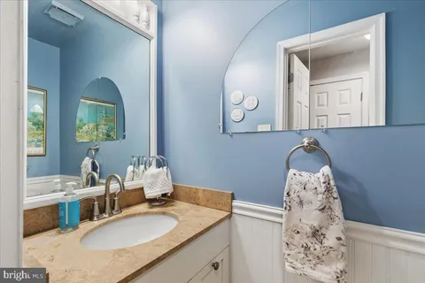 a kitchen with granite countertop a stove a sink and a microwave