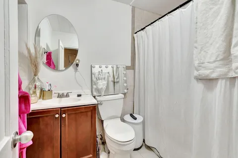 a bathroom with a sink mirror and toilet
