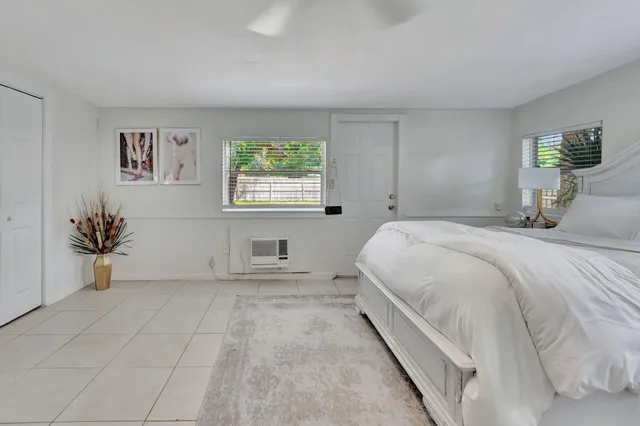 a spacious bedroom with a bed and a window