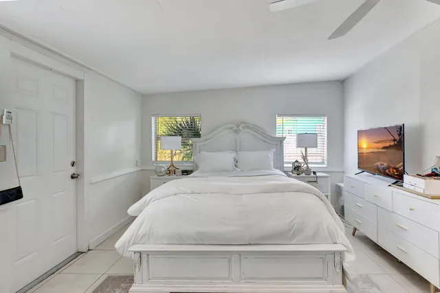 a large white bed in a white room