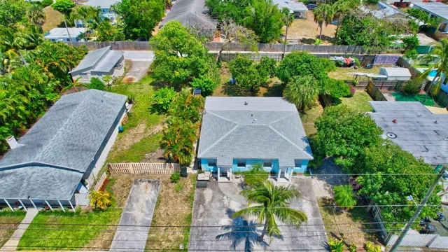 an aerial view of multiple houses with yard