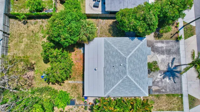 an aerial view of a house with garden space and a fountain