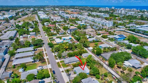 an aerial view of residential houses with outdoor space and street view