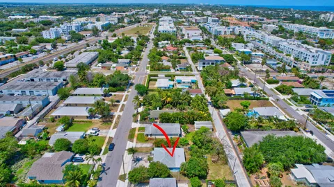 an aerial view of residential houses with outdoor space and trees