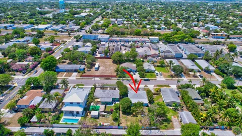an aerial view of residential houses with outdoor space and street view