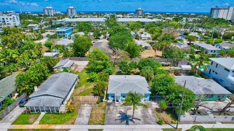 an aerial view of multiple houses with yard