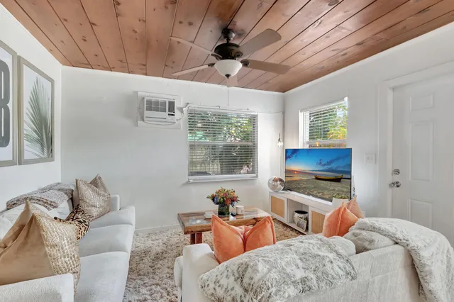 a bedroom with furniture a flat screen tv and a fireplace