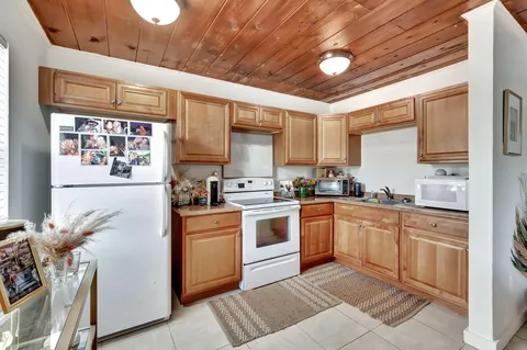 a kitchen with stainless steel appliances granite countertop a stove sink and cabinets