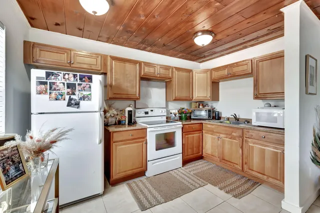a kitchen with stainless steel appliances granite countertop a stove sink and cabinets