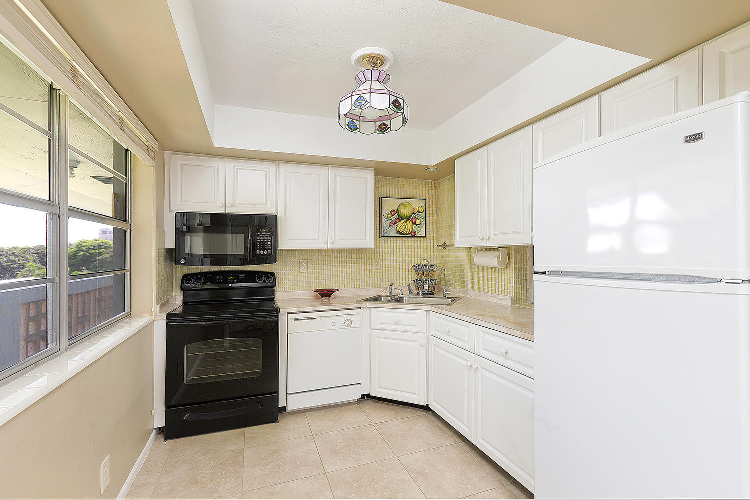 20 Southeast 13th Street, Unit C1 Boca Raton, FL 33432 - Photo 2 of 19 a kitchen with stainless steel appliances a refrigerator sink and stove