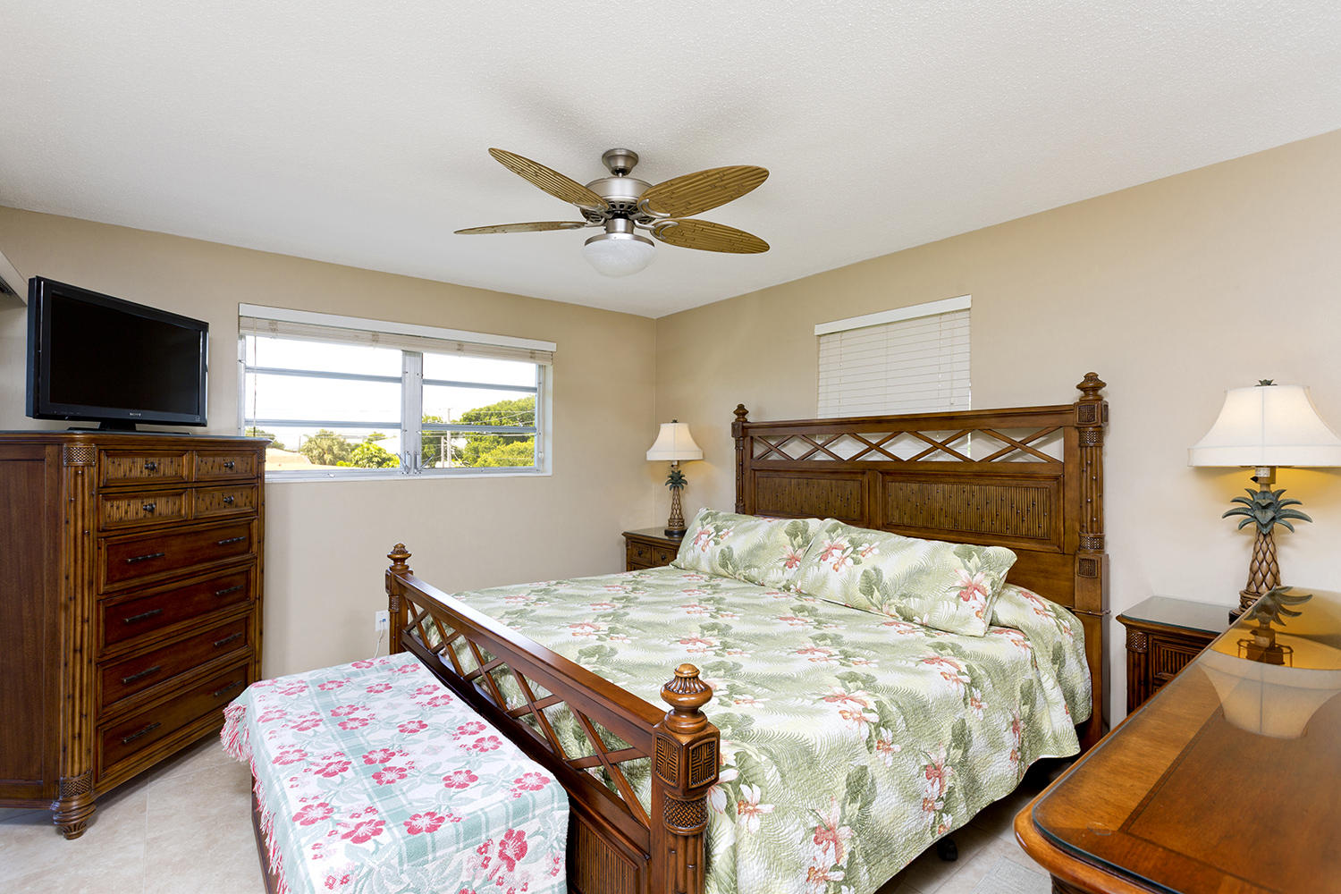 20 Southeast 13th Street, Unit C1 Boca Raton, FL 33432 - Photo 9 of 19 a bedroom with a bed and a flat screen tv