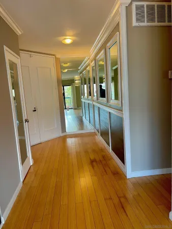 a view of gallery with wooden floor