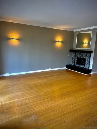 a view of an empty room with a fireplace
