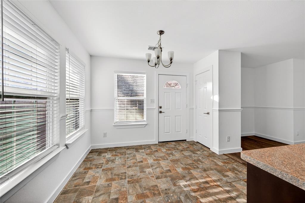 704 East Sycamore Street Sherman, TX 75090 - Photo 11 of 32 a view of a livingroom with wooden floor and windows