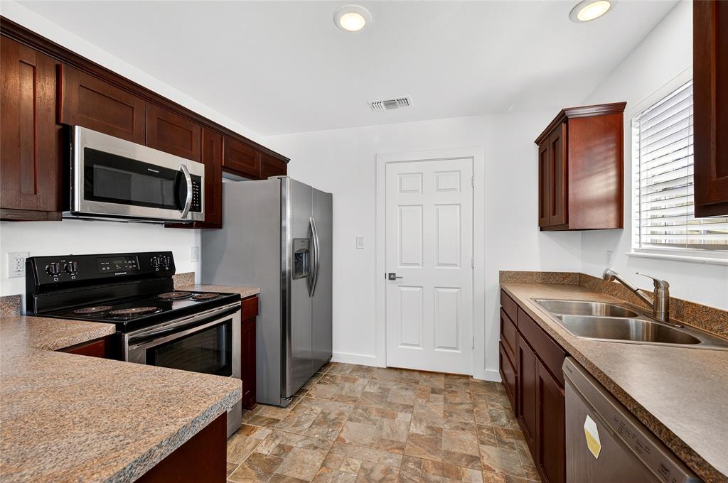 704 East Sycamore Street Sherman, TX 75090 - Photo 13 of 32 a kitchen that has a sink and a stove top oven