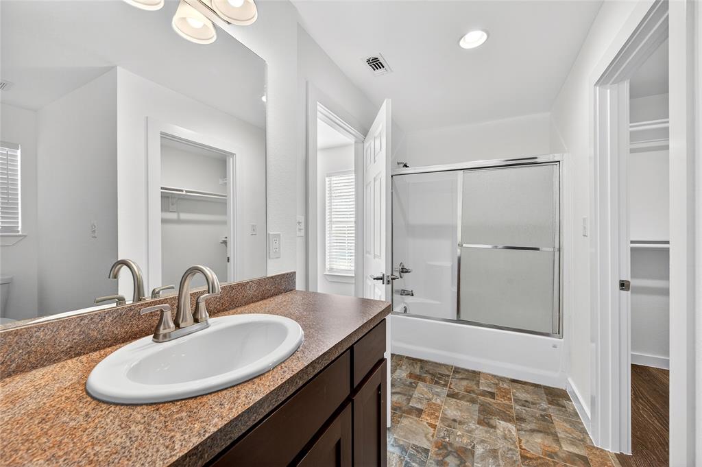 704 East Sycamore Street Sherman, TX 75090 - Photo 23 of 32 a bathroom with a sink and a mirror