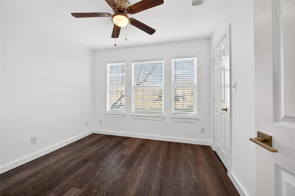704 East Sycamore Street Sherman, TX 75090 - Photo 24 of 32 a view of an empty room with wooden floor and a window