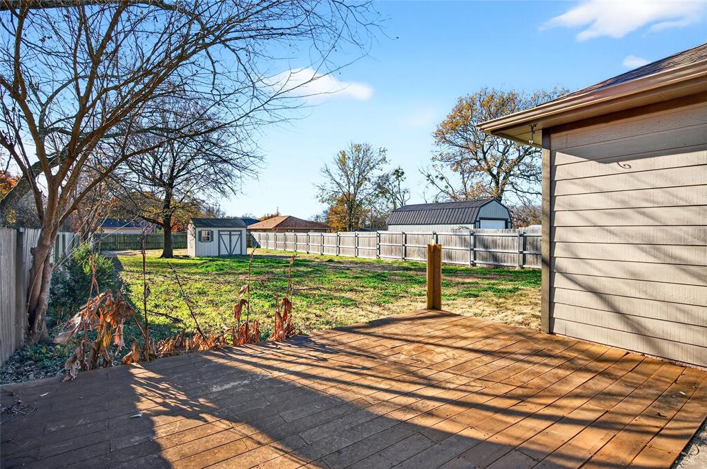 704 East Sycamore Street Sherman, TX 75090 - Photo 27 of 32 a view of a house with backyard and a tree