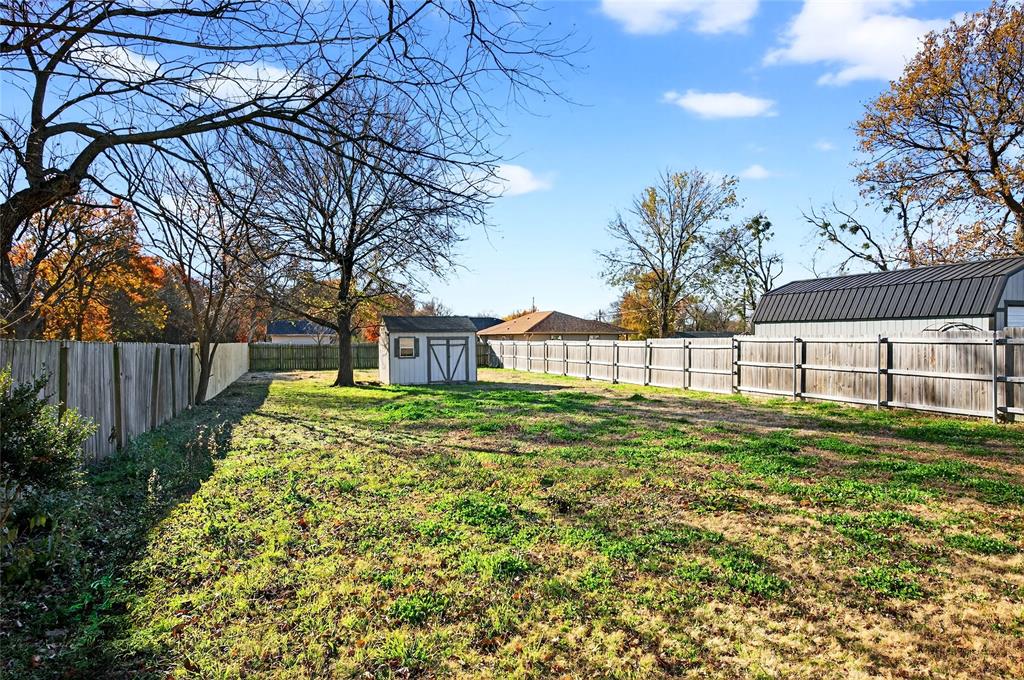 704 East Sycamore Street Sherman, TX 75090 - Photo 28 of 32 a view of a house with a yard