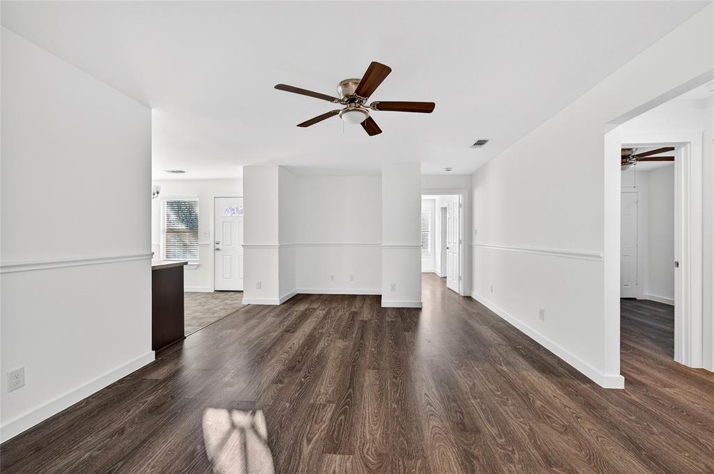 704 East Sycamore Street Sherman, TX 75090 - Photo 4 of 32 an empty room with wooden floor and windows