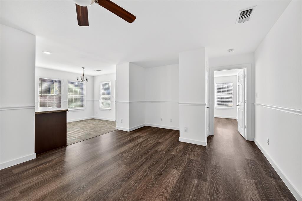 704 East Sycamore Street Sherman, TX 75090 - Photo 5 of 32 an empty room with wooden floor and windows