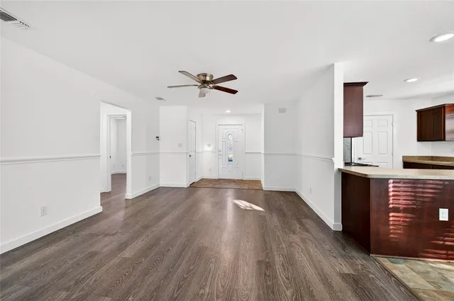 a view of kitchen with sink and refrigerator