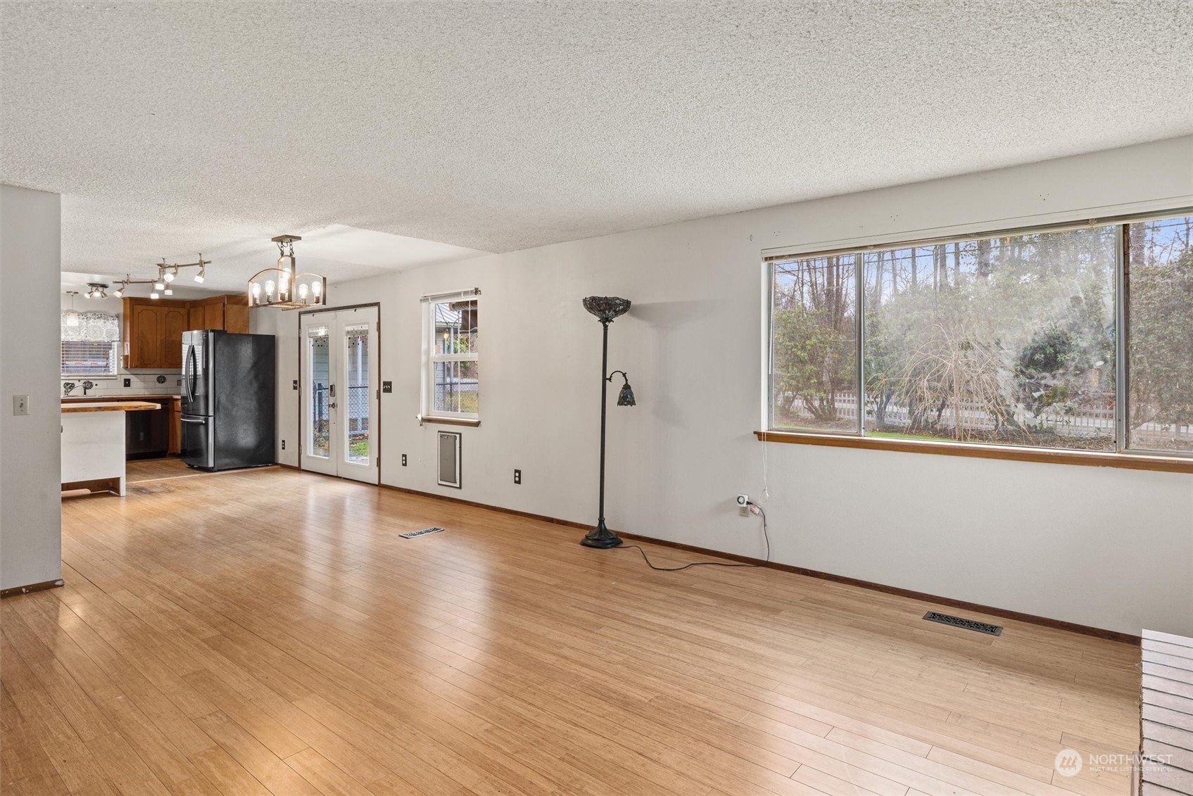 32717 Sultan Basin Road Sultan, WA 98294 - Photo 16 of 31 a view of a big room with wooden floor and windows