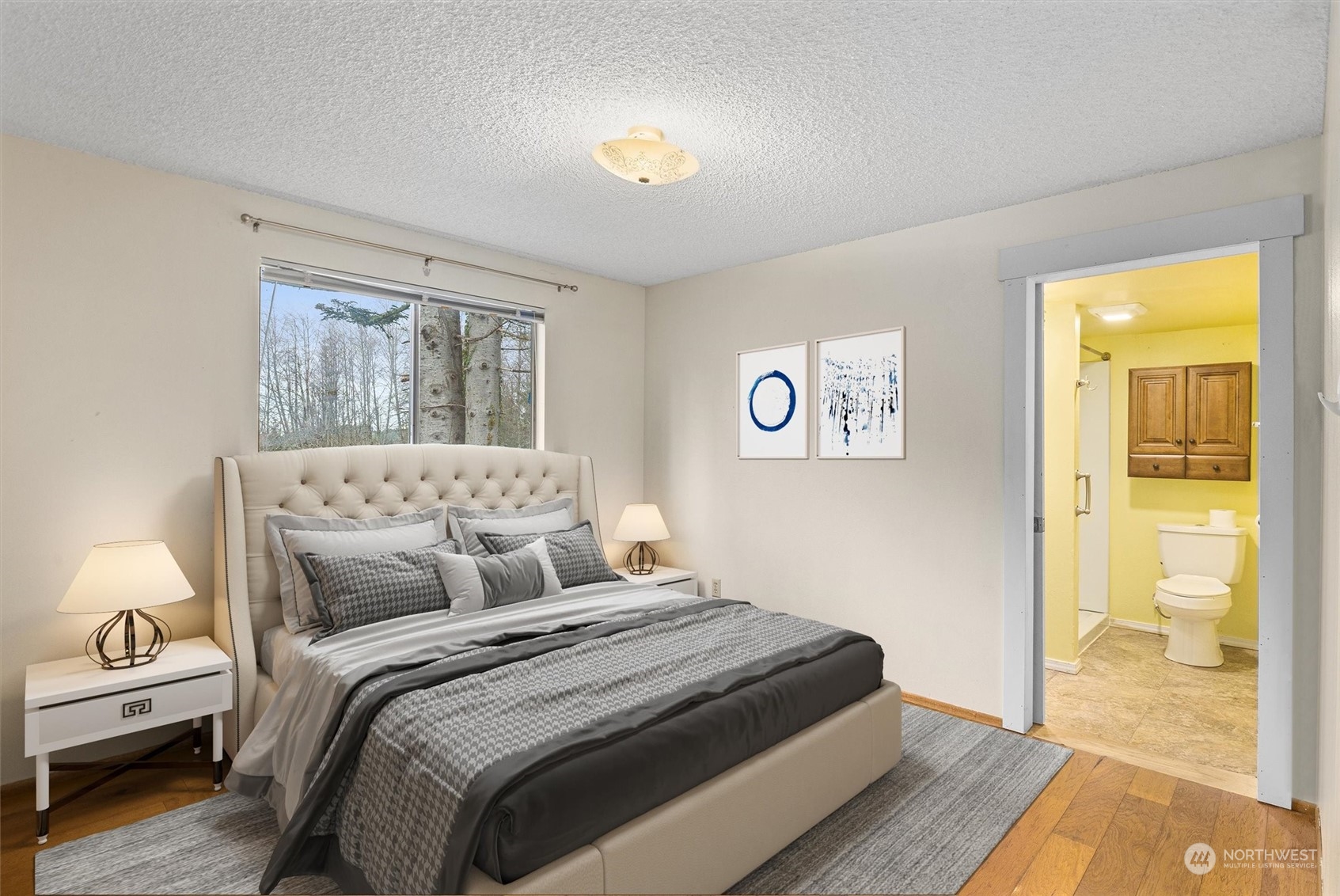 32717 Sultan Basin Road Sultan, WA 98294 - Photo 22 of 31 a bedroom with a bed and wooden floor