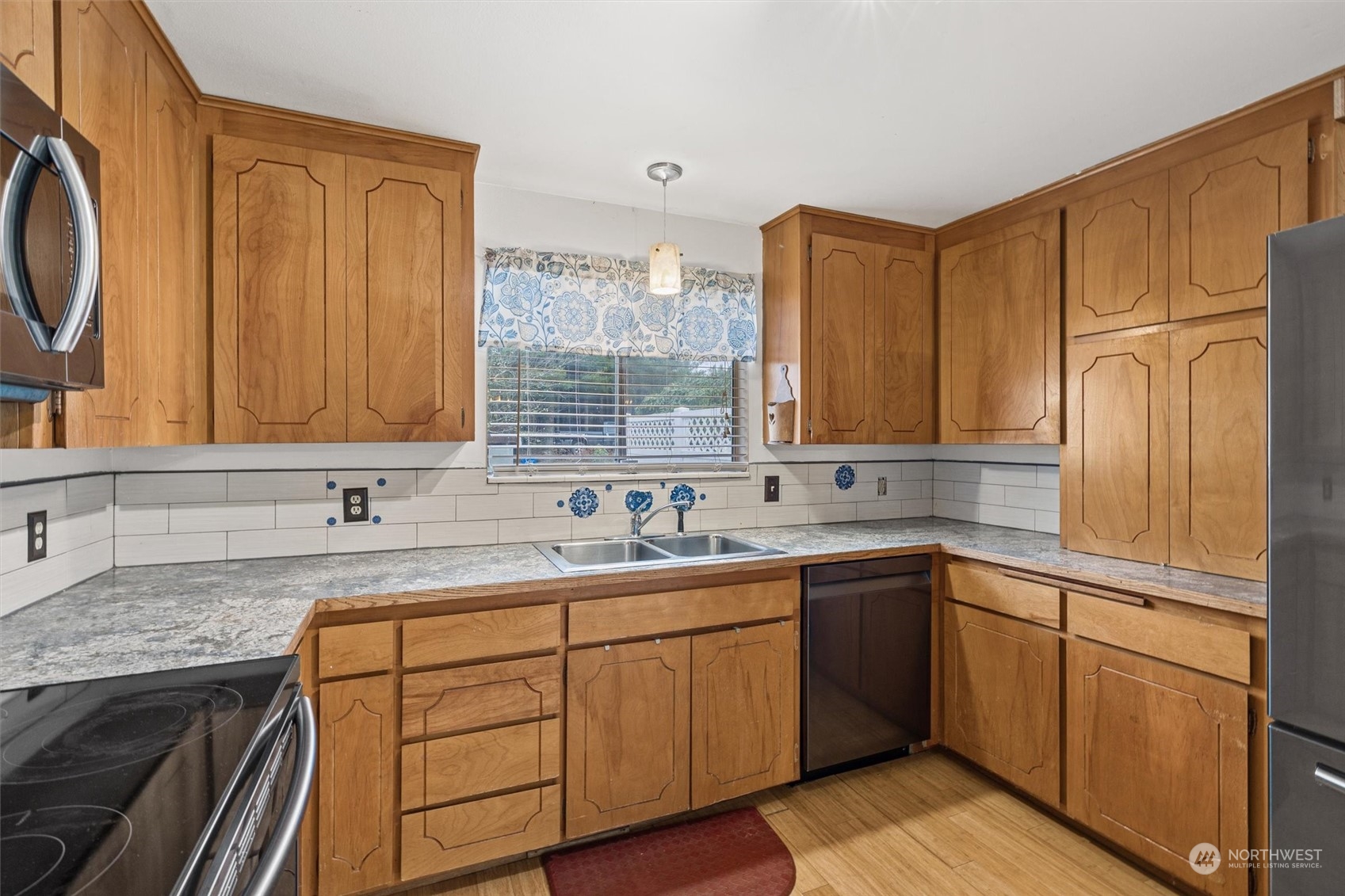 32717 Sultan Basin Road Sultan, WA 98294 - Photo 10 of 31 a kitchen with a sink stove and cabinets