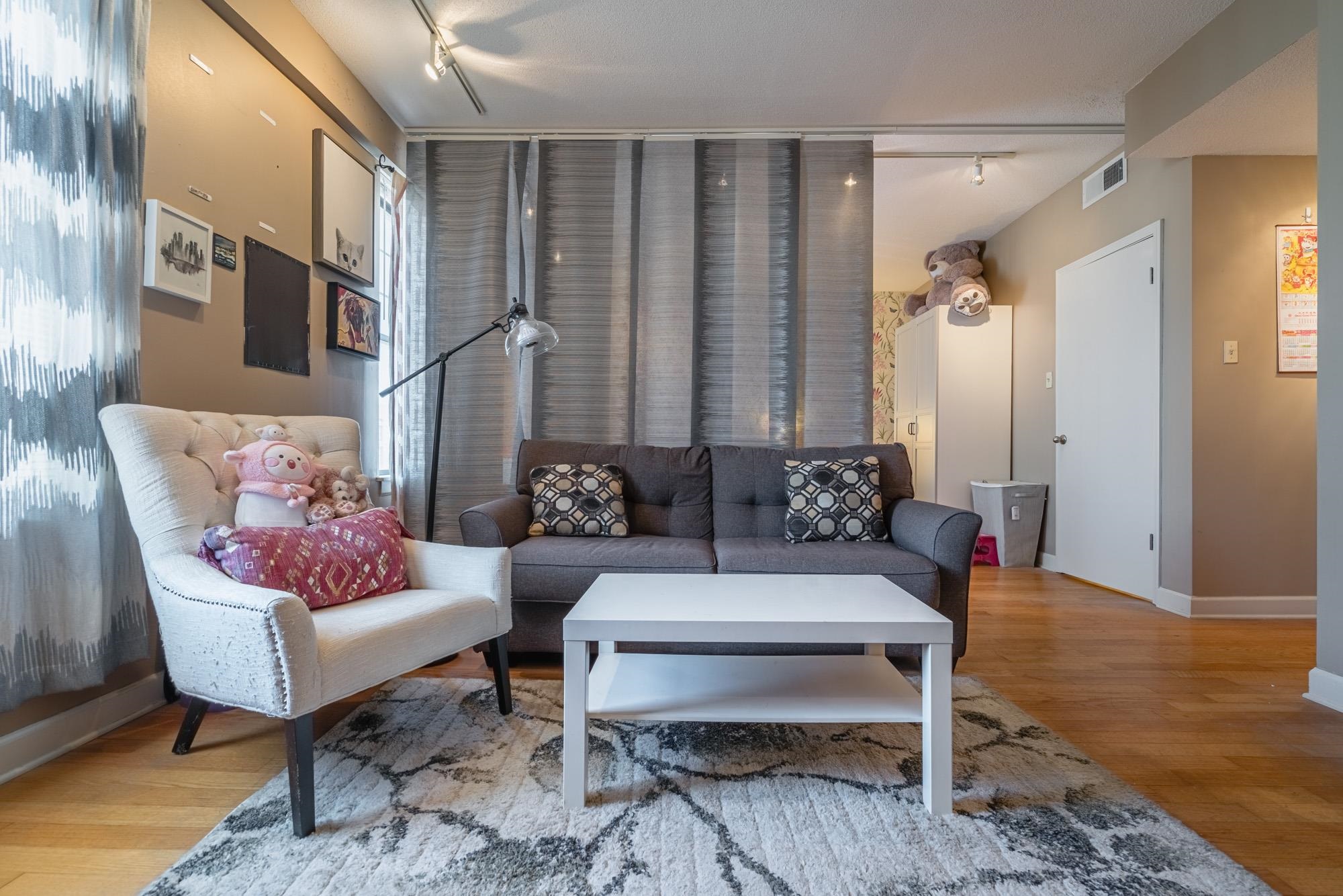 109 North Main Street, Unit 908 Memphis, TN 38103 - Photo 13 of 22 a living room with furniture and wooden floor