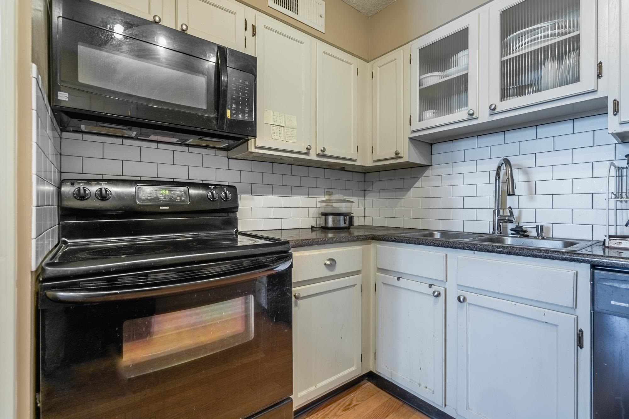 109 North Main Street, Unit 908 Memphis, TN 38103 - Photo 9 of 22 a kitchen with stainless steel appliances a stove microwave and sink