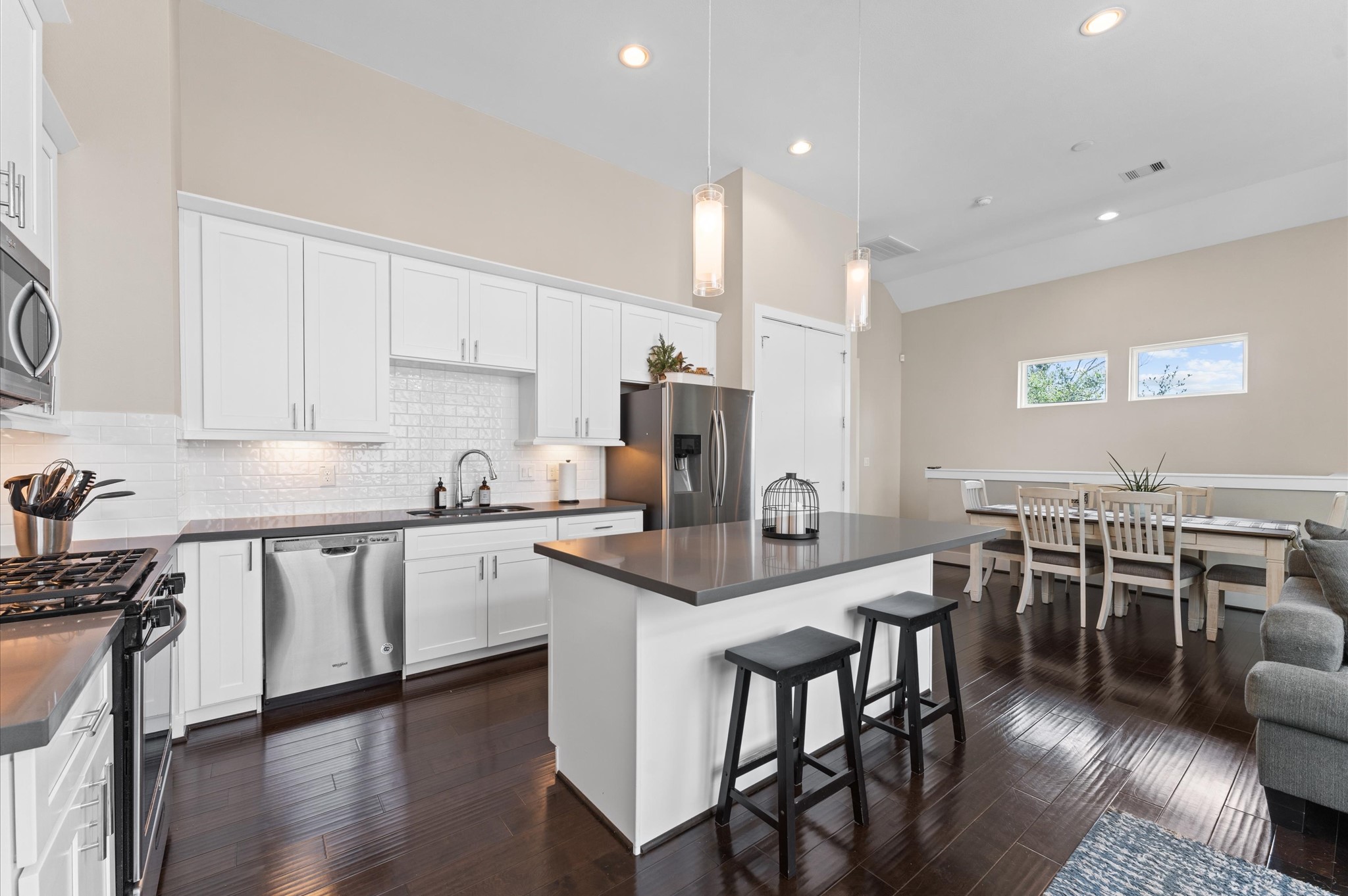 2422 Cochran Street Houston, TX 77009 - Photo 14 of 31 Tall cabinets, under-cabinet lighting, a subway tile backsplash, island seating, and stainless steel appliances! This kitchen has it all!