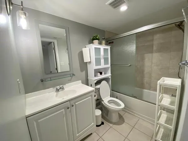 a bathroom with a sink toilet tub and shower
