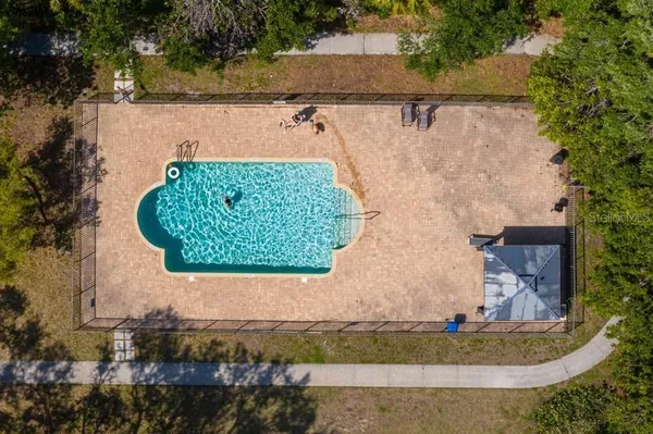 an aerial view of a house with a yard