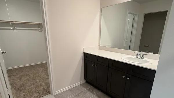 a bathroom with a double vanity sink a and mirror