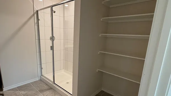 a bathroom with a glass shower door