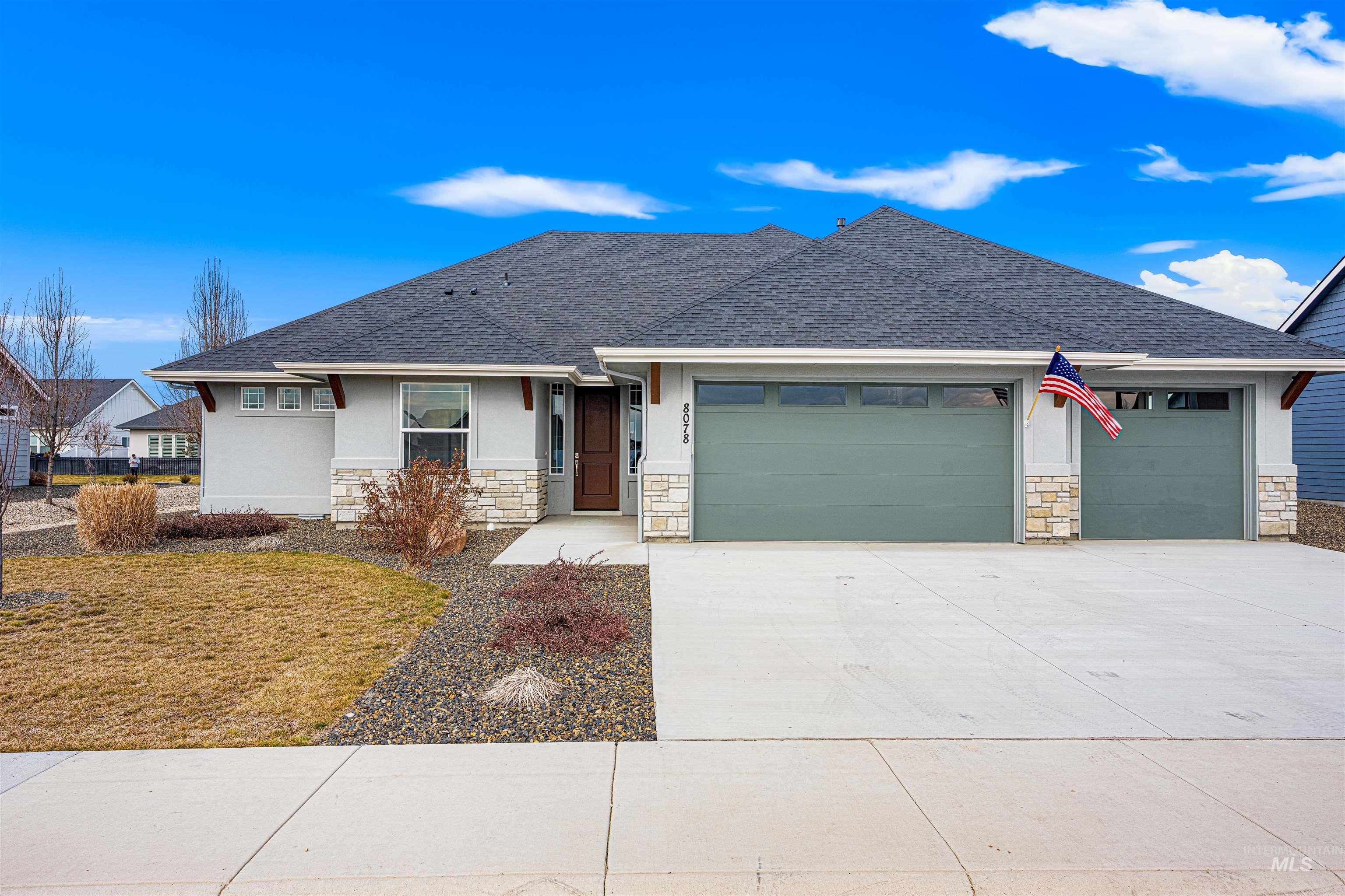 8078 Tandy Cv Street Middleton, ID 83644 - Photo 1 of 40 View of front of house featuring a shingled roof, stone siding, a garage, driveway, and stucco siding
