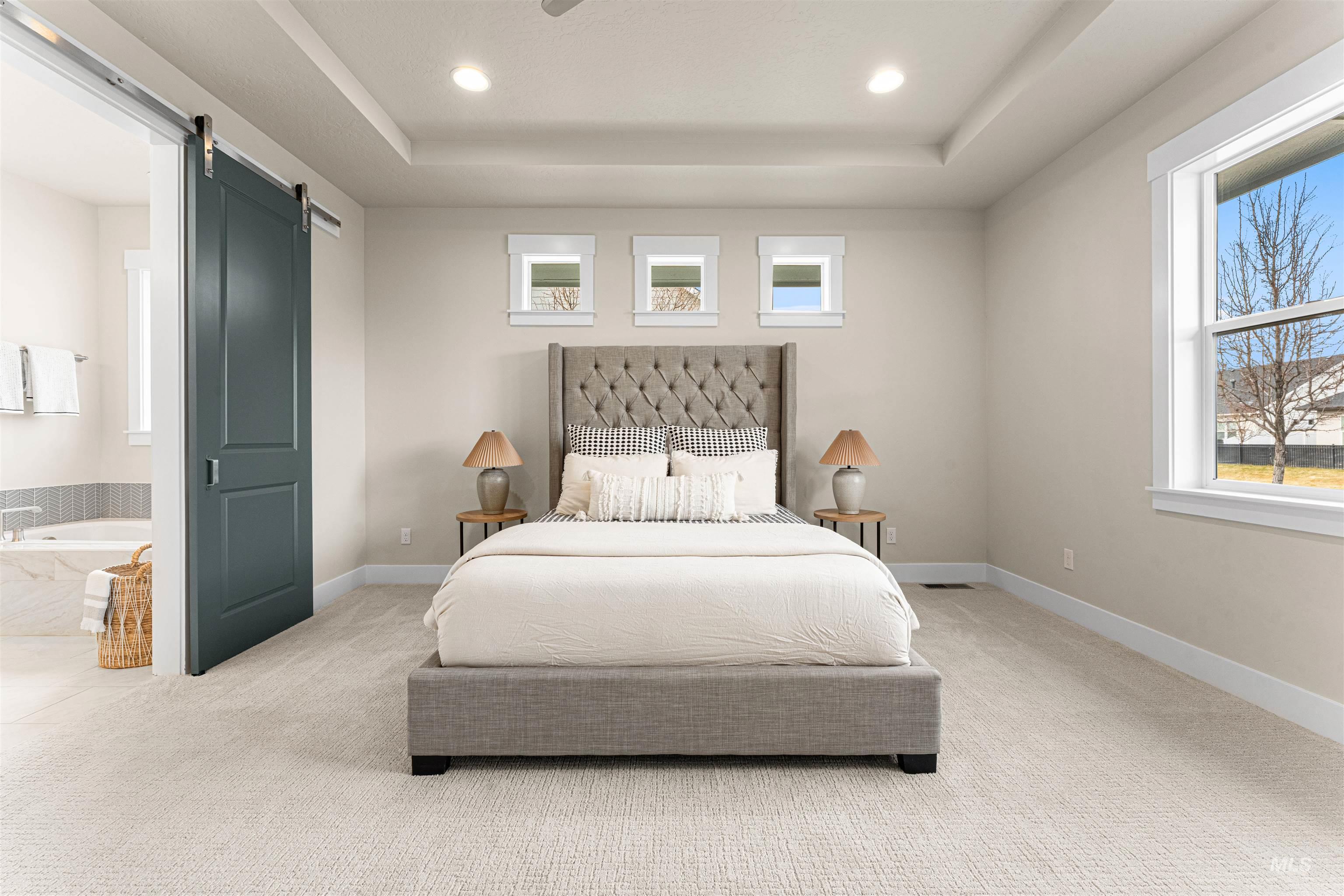 8078 Tandy Cv Street Middleton, ID 83644 - Photo 21 of 40 Bedroom with a barn door, carpet, a tray ceiling, and recessed lighting