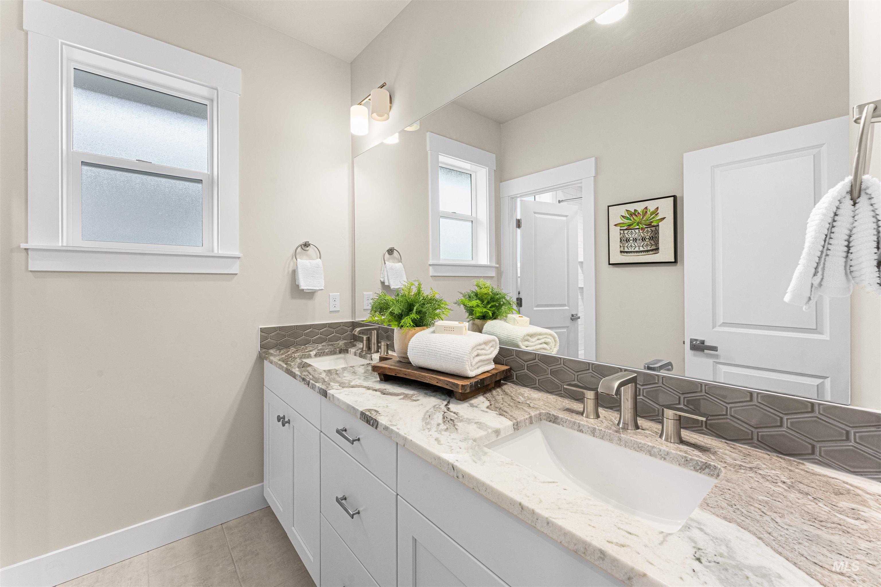 8078 Tandy Cv Street Middleton, ID 83644 - Photo 31 of 40 Bathroom featuring double vanity and light tile patterned flooring